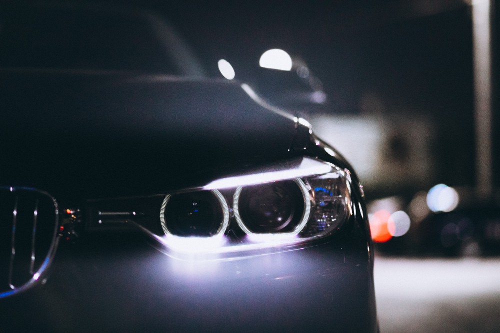 Detailed close-up of a car's headlights at night, illustrating the importance of headlight lamp shades and vehicle care.