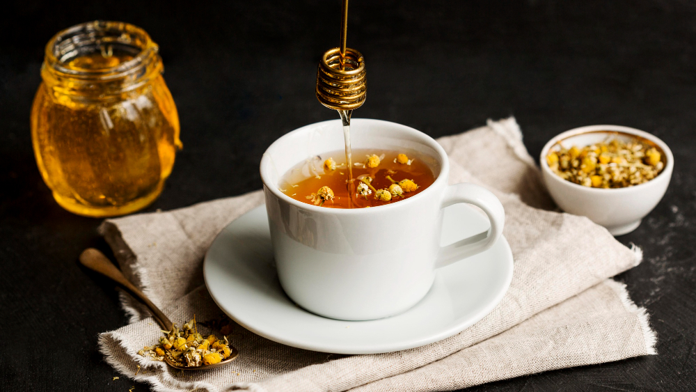 Refined gold honey and green coffee tea elegantly displayed on a black background, highlighting their luxurious appearance.