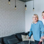 A nurse taking care of an old women in a nursing home