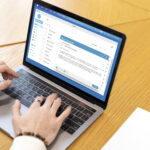 young-man-studying-library-using-his-laptop