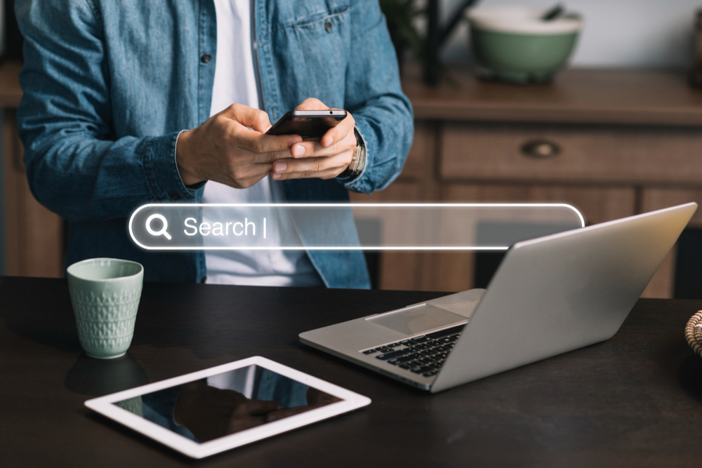 Man using his gadgets to search online