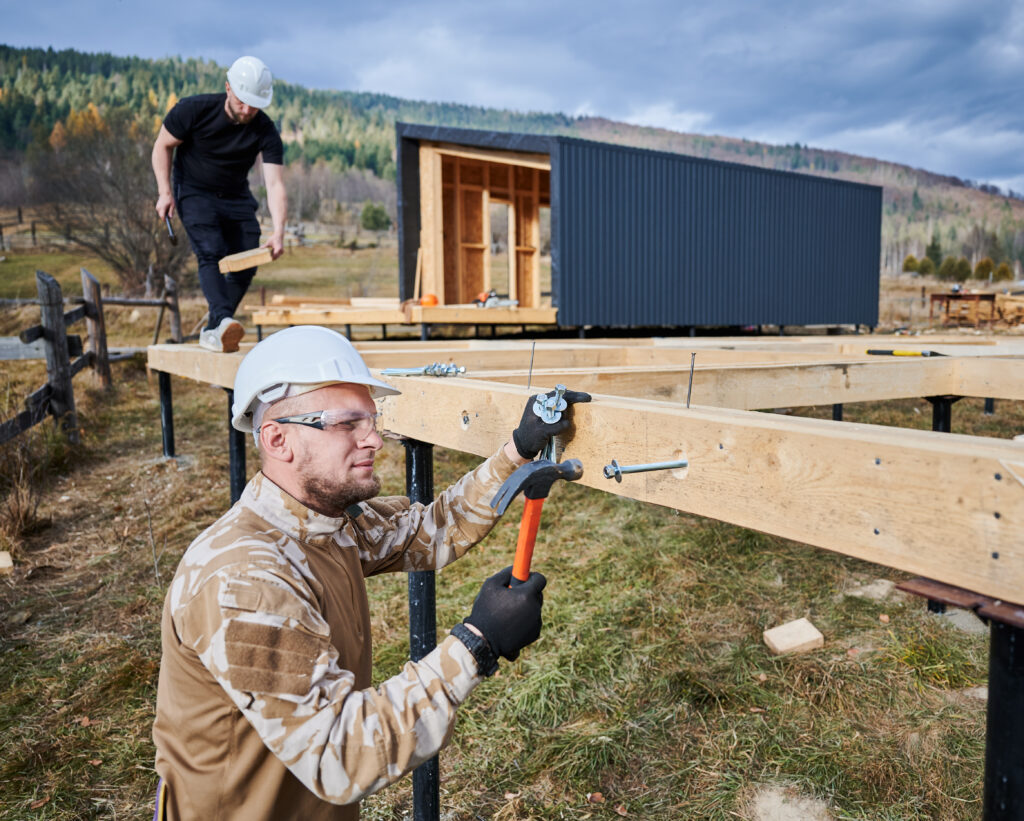 man-worker-hammering-while-building-wooden-frame-house-1024x821 Reliable Deck Services Portland – Cedar Mill Deck Company